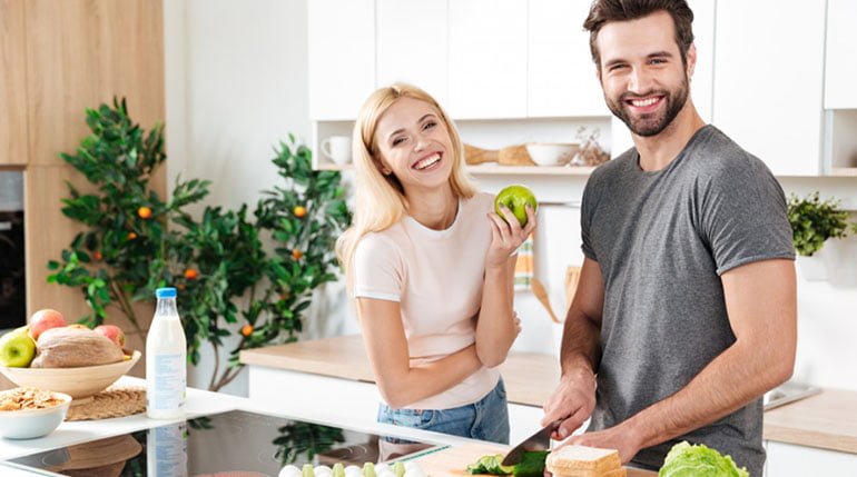 mężczyzna i kobieta przygotowujący zdrowy posiłek
