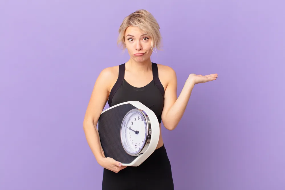 kobieta zastanawia się jak pozbyć się zbędnych kilogramów